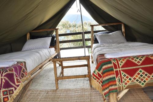Postel nebo postele na pokoji v ubytování Nyungwe Nziza Ecolodge