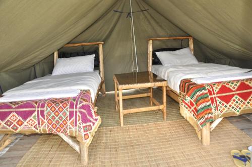 Postel nebo postele na pokoji v ubytování Nyungwe Nziza Ecolodge