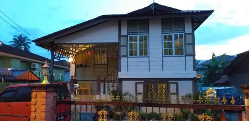 a model of a house with a fence at Teratak Opah Kamunting in Taiping