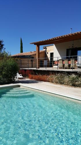 a swimming pool in front of a house at Villa Chamarel in Carcès