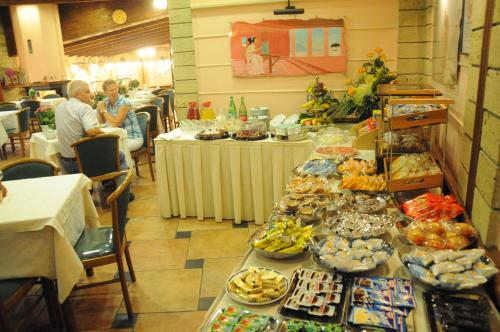 a buffet line with many different types of food at Hotel Grillo Verde in Torre Annunziata