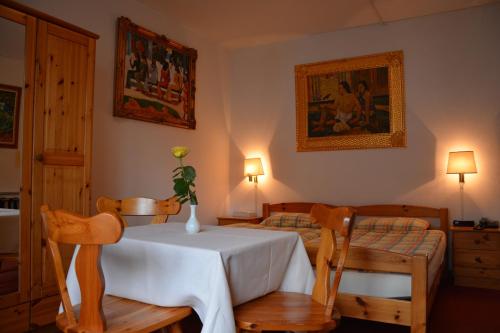 a bedroom with a table and two chairs with a vase on it at Hotel Dischma - FREE BUS AND TRAIN TICKET in Lugano