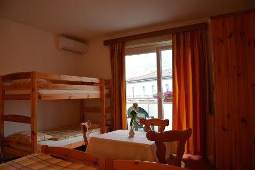 a bedroom with two bunk beds and a window at Hotel Dischma - FREE BUS AND TRAIN TICKET in Lugano