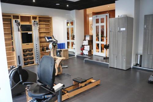 a gym with a treadmill and a chair in a room at Splendid Hotel & Spa Nice in Nice