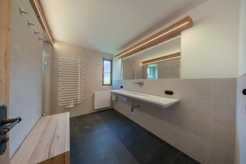 a bathroom with a sink and a mirror at Getznerhof in Westendorf