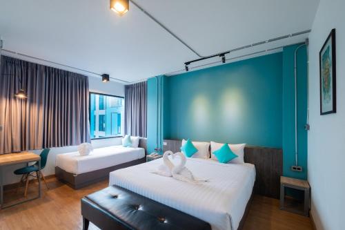 Postel nebo postele na pokoji v ubytování S.22 Hotel Suratthani