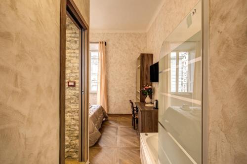 a bathroom with a tub and a sink and a desk at AMICI GUESTHOUSE in Rome