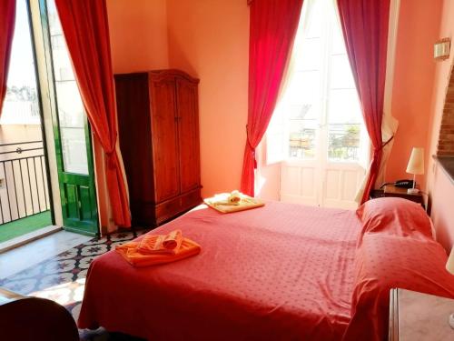 a bedroom with a bed and a dresser at Villa Mabel in Taormina
