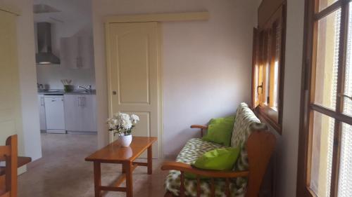 a living room with a couch and a table at Atic Casa Llebra in Roquetas