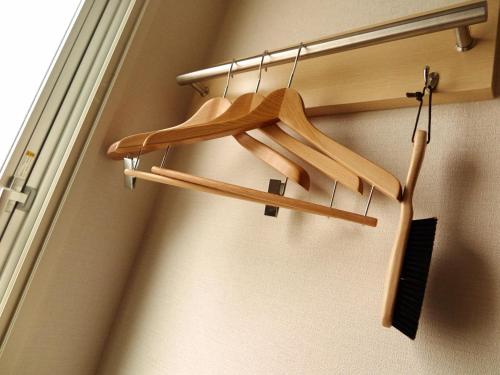 a bunch of wooden hangers in a room at Super Hotel JR Nara Ekimae Sanjo Dori in Nara
