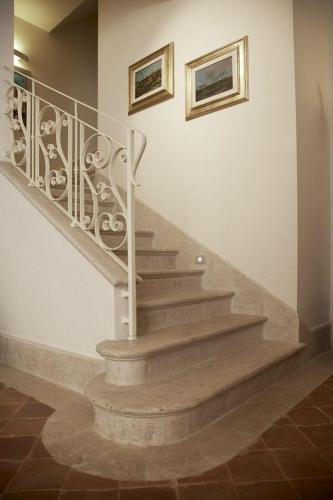 a staircase in a house with a stair railing at Hotel & Residenza 100 Torri in Ascoli Piceno