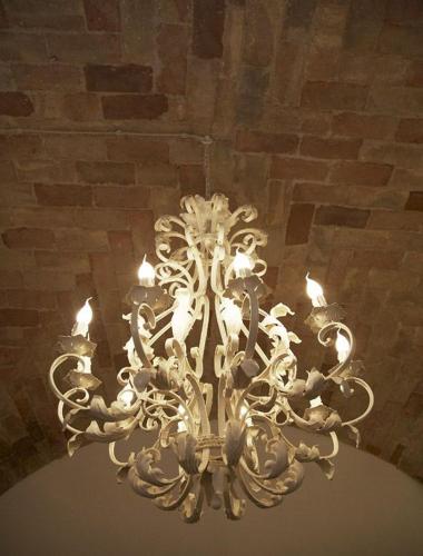 a chandelier hanging from a ceiling in a room at Hotel & Residenza 100 Torri in Ascoli Piceno