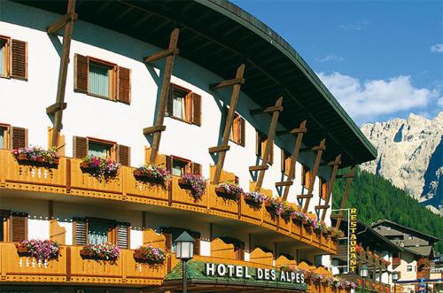 a hotel with flower boxes on the side of a building at Hotel Des Alpes in Selva di Val Gardena