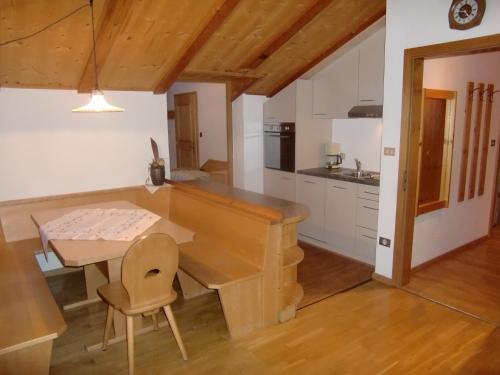a kitchen with a wooden table and a dining room at Residence Texel in Pfelders