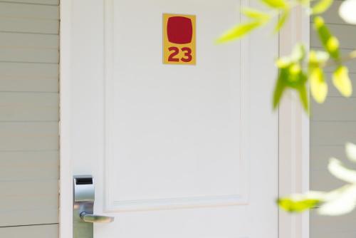 a white door with the number on it at The Originals Access, Hôtel Saint-Flour in Saint-Flour
