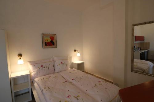 a bedroom with a bed and a mirror at Villa SORENTO in Mielno