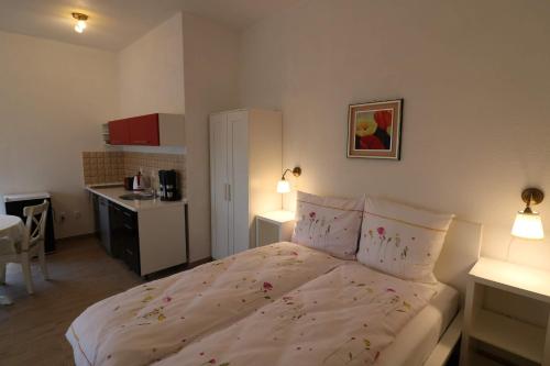a bedroom with a bed with flowers on it at Villa SORENTO in Mielno