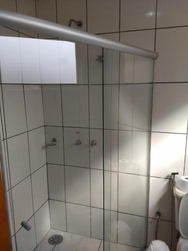 a bathroom with a shower and a toilet at Hotel Soldera Inn in Sertãozinho