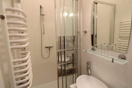 a bathroom with a shower with a toilet and a sink at Villa SORENTO in Mielno