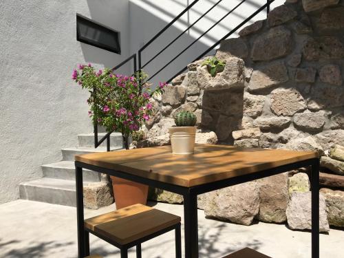 a wooden table and chairs on a patio with stairs at Romance City Hotel in Morelia