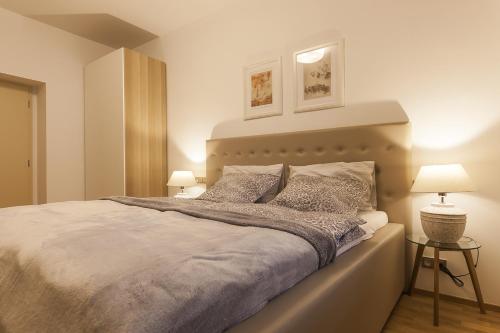 a bedroom with a large white bed with two lamps at Prague Expat House in Prague