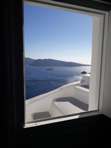 a view of the ocean from a window of a boat at Olympic Villas in Oia