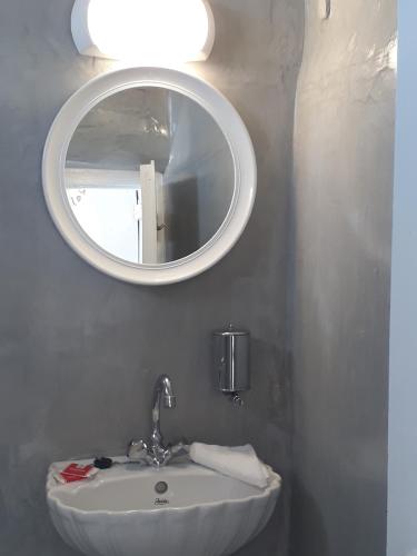 a bathroom with a sink and a mirror at Olympic Villas in Oia