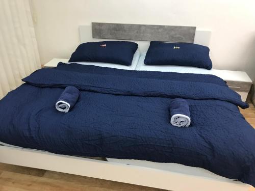 a bed with blue blankets and pillows on it at Old Town Apartments R11 in Olomouc