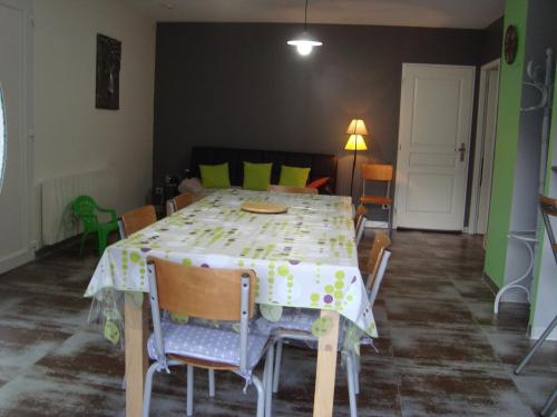 a dining room with a table and chairs and a room with at Les coquelicots in Luz-Saint-Sauveur