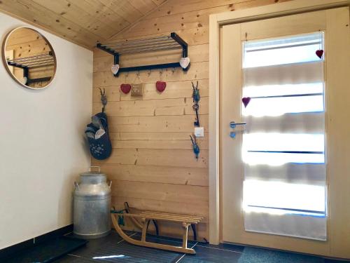 a room with a wooden wall with a door at Chalet Rouge Coeur in Fenalet Sur Bex