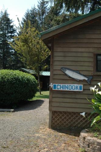 a sign on the side of a building with a boat on it at Park Motel and Cabins in Florence