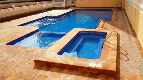 a swimming pool with blue water in a house at Apartament Veneziola in San Javier