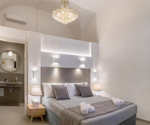 a bedroom with a large bed with two towels on it at ReLuxe Private Wellness in Lecce