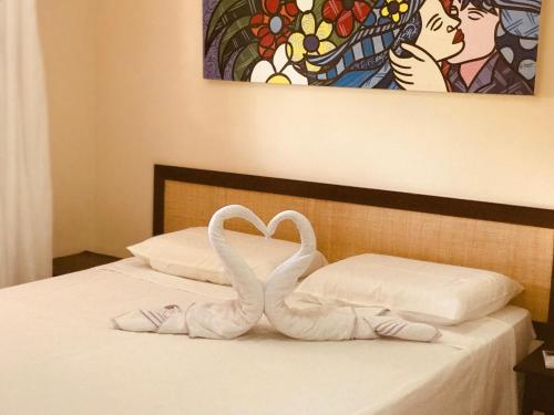 two swans made out of towels on a bed at Pipa Flat Solar in Pipa