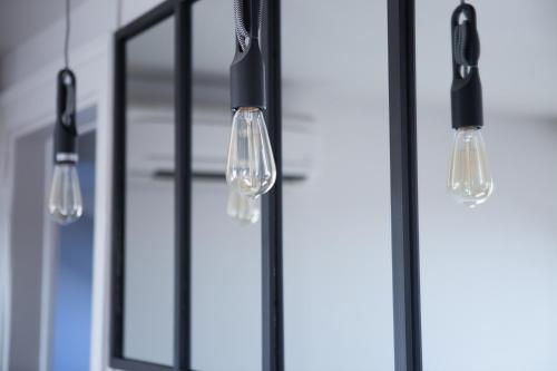 a group of lights hanging in a kitchen at 1834&Spa Colmar in Colmar
