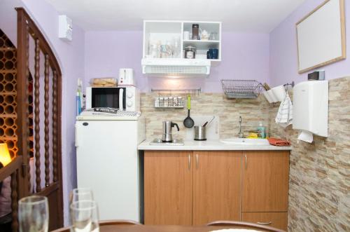 a small kitchen with a sink and a refrigerator at Apartment Vacarisses Torreblanca Estación, Piscina Privada in Vacarisas