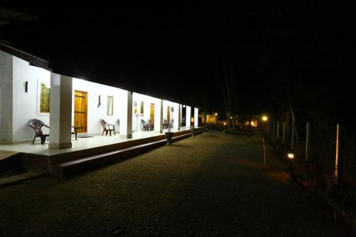 a night view of a building with lights on it at Amadi Rest in Kataragama