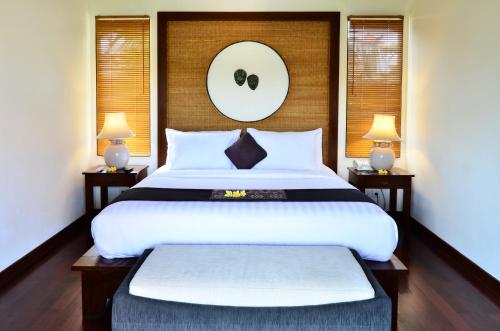 a bedroom with a large white bed with two lamps at The Khayangan Dreams Villa, Seminyak in Seminyak