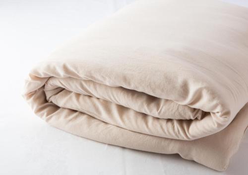 a close up of a pillow on a bed at Hotel Claiton Esaka in Suita