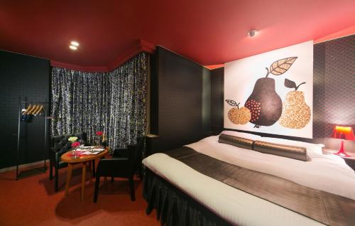 a hotel room with a bed and a table at Grand Hotel Staymore -Adult Only in Natori