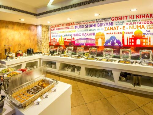 a buffet line with many different types of food at Hotel Rockdale in Visakhapatnam