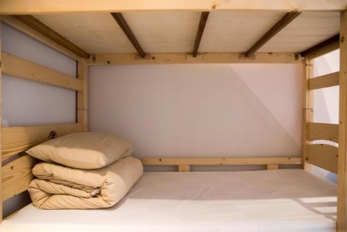 a bunk bed with two pillows in a room at 框框背包客棧 Kuang Kuang Hostel in Longjing