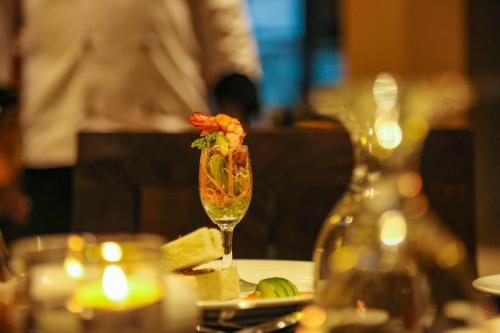 a table with a wine glass with a shrimp on it at Oak Ray Wild Yala in Tissamaharama
