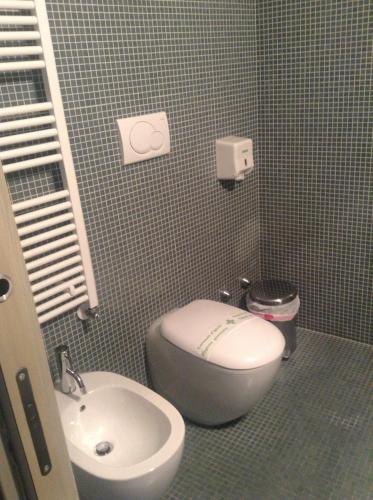 a bathroom with a toilet and a sink at Alloggi Taverna Caorlina in Caorle