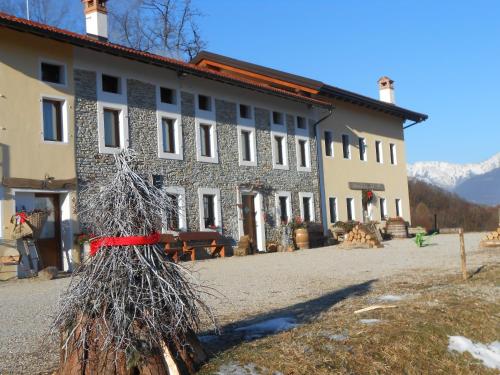 a building with a red ribbon around it at Agriturismo La Casa Nei Boschi in Colderù