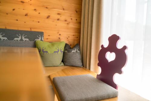 a room with a table with a bench and pillows at Sapia Hotel Rheinsberg in Bad Säckingen
