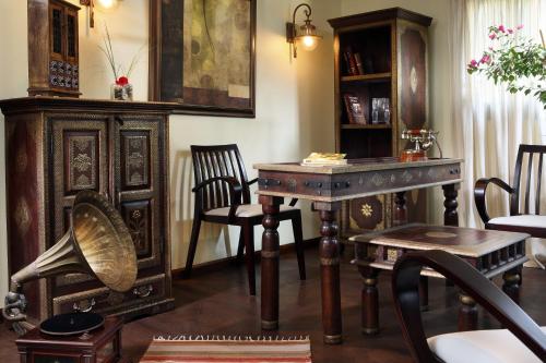a room with a table and chairs and a desk at Sonesta Dahabeya Amirat I - Nile Cruise Ship From Luxor to Aswan 7 nights in Luxor