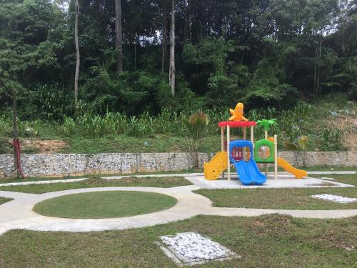 a playground with a slide in a garden at The Quintet, Tower Ethel in Tanah Rata