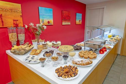 a buffet with many different types of food on a table at Castello Hotel in Rio