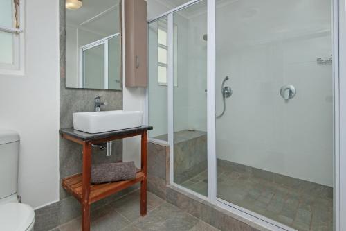 a bathroom with a sink and a shower at K5 White House in Hermanus